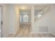 Bright and airy living area with new laminate flooring, staircase, and natural light at 7716 Bauble Ave, Las Vegas, NV 89128
