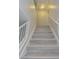 Staircase with gray wood-look steps and white railings, leading to the upper level of the home at 7716 Bauble Ave, Las Vegas, NV 89128