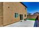 Spacious backyard featuring a concrete patio, stucco wall, and lush green grass, perfect for relaxation and entertainment at 7760 Trends Ct, Las Vegas, NV 89149