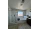 Bathroom featuring shower, bathtub, window, and tile flooring at 7760 Trends Ct, Las Vegas, NV 89149