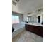 Bright bathroom features a soaking tub, dual sinks, and tile flooring at 7760 Trends Ct, Las Vegas, NV 89149