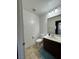 Cozy bathroom features a vanity with dark cabinets and a tiled floor at 7760 Trends Ct, Las Vegas, NV 89149