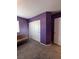 Bedroom with purple walls and futon at 7760 Trends Ct, Las Vegas, NV 89149