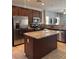 Well-lit kitchen features stainless steel appliances, granite counters, and an island at 7760 Trends Ct, Las Vegas, NV 89149