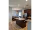 Eat-in kitchen features an island with granite countertop, and an adjacent dining area at 7760 Trends Ct, Las Vegas, NV 89149