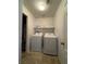 Convenient laundry room with white washer and dryer, and overhead shelving at 7760 Trends Ct, Las Vegas, NV 89149