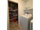 Laundry room features washer and dryer, shelving, and extra storage space at 7760 Trends Ct, Las Vegas, NV 89149