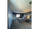Spacious main bedroom with a large bed, dark grey walls, and natural light at 7760 Trends Ct, Las Vegas, NV 89149