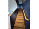 Carpeted staircase with wood railing leads to the upper level of the home at 7760 Trends Ct, Las Vegas, NV 89149
