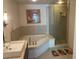 Modern bathroom showcasing a soaking tub, shower, and double sinks at 8925 W Flamingo Rd # 105, Las Vegas, NV 89147