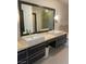 Elegant bathroom featuring double sinks, a large mirror, and a walk-in shower at 8925 W Flamingo Rd # 105, Las Vegas, NV 89147