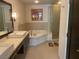 Luxurious bathroom featuring a soaking tub, a shower, and a double vanity at 8925 W Flamingo Rd # 105, Las Vegas, NV 89147