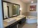 Bright bathroom with double sinks, soaking tub, and a shower, and modern finishes at 8925 W Flamingo Rd # 105, Las Vegas, NV 89147