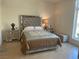 Well-lit bedroom showcasing mirrored furniture, stylish bed, and ample space at 8925 W Flamingo Rd # 105, Las Vegas, NV 89147