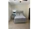 Cozy bedroom with neutral colors, comfortable bedding, and a bedside table with lamp at 8925 W Flamingo Rd # 105, Las Vegas, NV 89147