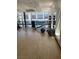 Bright gym space with pool view featuring cardio equipment, free weights, and balance balls at 8925 W Flamingo Rd # 105, Las Vegas, NV 89147