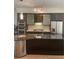Modern kitchen featuring granite countertops, stainless steel appliances and breakfast bar seating at 8925 W Flamingo Rd # 105, Las Vegas, NV 89147