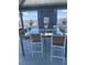 This outdoor dining area features a glass table, seating for eight, and a built in grilling station at 8925 W Flamingo Rd # 105, Las Vegas, NV 89147