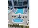 Aerial view of a pool with lounge chairs and a hot tub at a modern apartment complex at 8925 W Flamingo Rd # 105, Las Vegas, NV 89147