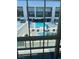 Elevated view of a pool surrounded by modern architecture, sun loungers, and blue umbrellas at 8925 W Flamingo Rd # 105, Las Vegas, NV 89147