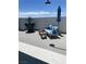 Rooftop patio lounge area with comfortable seating, side tables, shade umbrella and a decorative planter at 8925 W Flamingo Rd # 105, Las Vegas, NV 89147