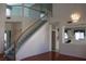Open-concept living space featuring a staircase, decorative lighting, and a glimpse of the kitchen at 8982 Emerald Waters Ct, Las Vegas, NV 89147