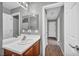 Clean secondary bathroom with modern fixtures, wood-look floors, and a white vanity at 9104 Pearl Cotton Ave, Las Vegas, NV 89149