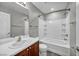 Well-lit bathroom featuring a vanity, toilet, and tub-shower combination with white tile surround at 9104 Pearl Cotton Ave, Las Vegas, NV 89149