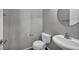 Powder bathroom with round mirror, toilet, and pedestal sink at 9104 Pearl Cotton Ave, Las Vegas, NV 89149