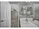 Bright bathroom showcasing a single vanity, mirror, and doorway leading to a carpeted bedroom at 9104 Pearl Cotton Ave, Las Vegas, NV 89149