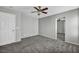 Inviting bedroom featuring gray walls, plush carpeting, and a doorway leading to an adjacent room at 9104 Pearl Cotton Ave, Las Vegas, NV 89149