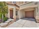 Close-up of covered entrance and single car garage with charming front yard landscaping at 9104 Pearl Cotton Ave, Las Vegas, NV 89149