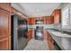 Kitchen with black appliances, wooden cabinets, and updated flooring and window shutters at 9104 Pearl Cotton Ave, Las Vegas, NV 89149