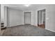 Open living room featuring neutral gray walls and plush carpeting at 9104 Pearl Cotton Ave, Las Vegas, NV 89149
