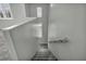 A staircase with gray walls and carpeted steps with a handrail at 9104 Pearl Cotton Ave, Las Vegas, NV 89149