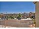 Neighborhood street showcasing townhomes in a suburban community on a sunny day from an elevated balcony at 9104 Pearl Cotton Ave, Las Vegas, NV 89149