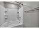 Close up on a tub-shower combination with a white tile surround, and a chrome shower head at 9104 Pearl Cotton Ave, Las Vegas, NV 89149