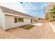 Backyard showing a small patio, neutral exterior walls, and a tile roof at 9514 Teton Vista Ave, Las Vegas, NV 89117