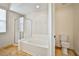 Bright bathroom features a soaking tub, separate shower, and neutral tile flooring at 9514 Teton Vista Ave, Las Vegas, NV 89117