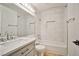 Bright bathroom with white vanity, marble tile, and glass enclosed shower at 9514 Teton Vista Ave, Las Vegas, NV 89117