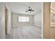 Spacious bedroom featuring ceiling fan, light wood flooring, and arched doorway at 9514 Teton Vista Ave, Las Vegas, NV 89117