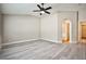 Large bedroom featuring an arched doorway, light wood floors, and neutral walls at 9514 Teton Vista Ave, Las Vegas, NV 89117