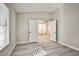Bright bedroom with wood floors and view to the next room through a set of white doors at 9514 Teton Vista Ave, Las Vegas, NV 89117