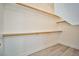 Walk-in closet with built-in shelving and light wood floors at 9514 Teton Vista Ave, Las Vegas, NV 89117