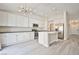 Modern kitchen with an island, stainless steel appliances, and white cabinets at 9514 Teton Vista Ave, Las Vegas, NV 89117