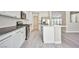 Clean kitchen featuring white cabinets, stainless steel appliances, and gray wood floors at 9514 Teton Vista Ave, Las Vegas, NV 89117
