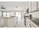Bright kitchen with a large island, stainless steel appliances, and gray wood floors at 9514 Teton Vista Ave, Las Vegas, NV 89117