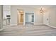 An open-concept living room flows to the kitchen with plank flooring and neutral paint at 9514 Teton Vista Ave, Las Vegas, NV 89117
