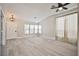 Spacious living room with high ceilings, plank flooring, and abundant natural light at 9514 Teton Vista Ave, Las Vegas, NV 89117