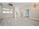 Bright and airy living room leads to a kitchen with plank flooring and neutral tones at 9514 Teton Vista Ave, Las Vegas, NV 89117
